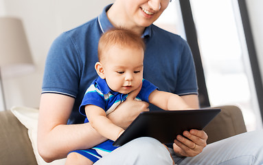 Image showing happy father and baby son with tablet pc at home