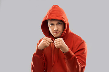 Image showing man in red hoodie fighting with fists or boxing