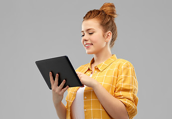 Image showing red haired teenage girl using tablet computer