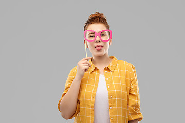 Image showing smiling red haired teenage girl with big glasses