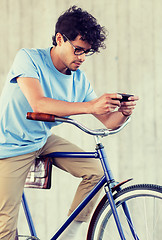 Image showing man with smartphone and fixed gear bike on street