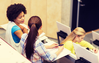 Image showing group of students talking in lecture hall