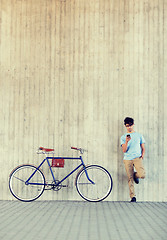 Image showing man with smartphone and fixed gear bike on street