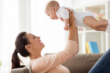 Image showing happy mother playing with little baby boy at home