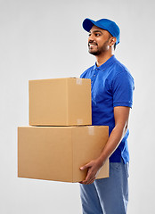 Image showing happy indian delivery man with parcel boxes