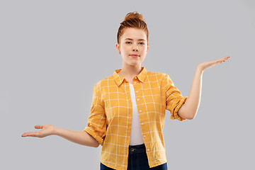 Image showing red haired teenage girl holding empty hands