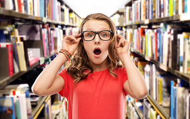 Image showing surprised student girl in glasses at library