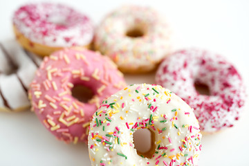 Image showing close up of glazed donuts on white table