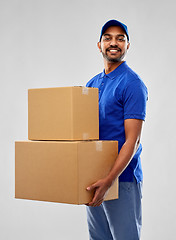 Image showing happy indian delivery man with parcel boxes