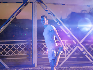 Image showing man jogging across the bridge in the city