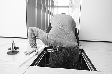 Image showing engineer connecting cables in server room