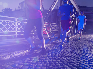 Image showing young people jogging across the bridge