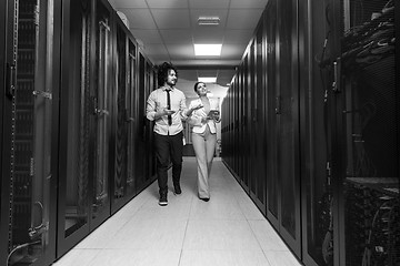 Image showing engineer showing working data center server room to female chief