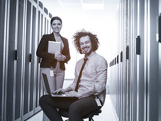 Image showing Team of young technicians working together on servers