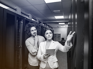 Image showing engineer showing working data center server room to female chief