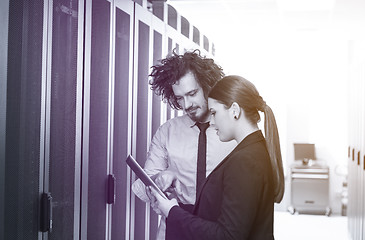 Image showing engineer showing working data center server room to female chief