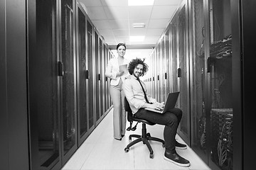 Image showing Team of young technicians working together on servers