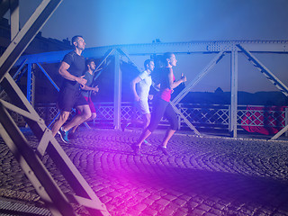 Image showing young people jogging across the bridge