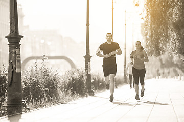 Image showing young couple jogging  in the city