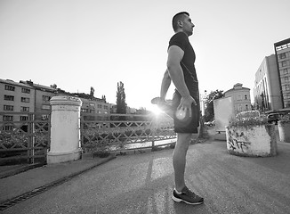 Image showing athlete man warming up and stretching