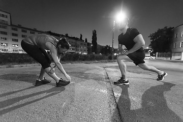 Image showing couple warming up and stretching