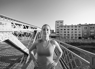 Image showing portrait of a jogging woman at sunny morning