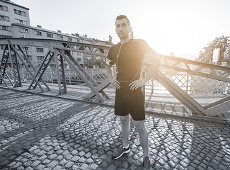 Image showing portrait of a jogging man at sunny morning