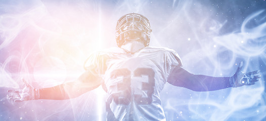 Image showing american football player celebrating after scoring a touchdown