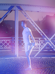 Image showing man jogging across the bridge in the city