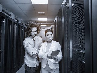 Image showing engineer showing working data center server room to female chief