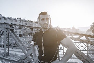 Image showing portrait of a jogging man at sunny morning