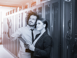 Image showing engineer showing working data center server room to female chief