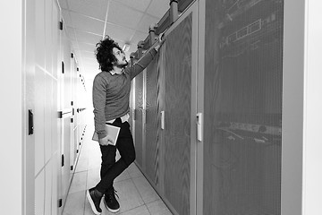 Image showing IT engineer working on a tablet computer in server room