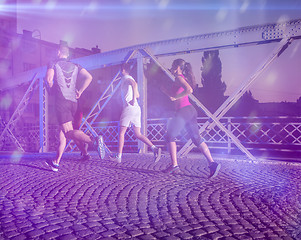 Image showing young people jogging across the bridge