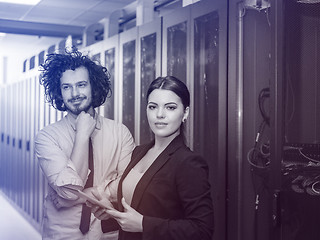 Image showing engineer showing working data center server room to female chief