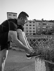 Image showing man tying running shoes laces