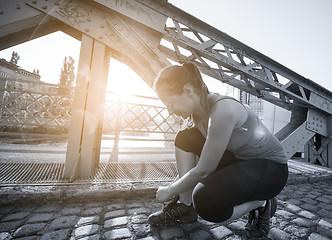 Image showing woman tying running shoes laces