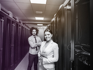 Image showing engineer showing working data center server room to female chief