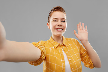 Image showing smiling red haired teenage girl taking selfie