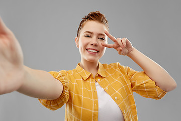 Image showing redhead teenage girl taking selfie making peace