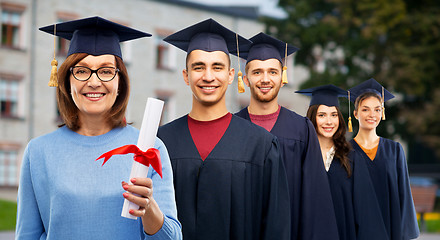 Image showing happy senior graduate student woman with diploma