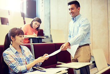 Image showing teacher giving tests to students at lecture