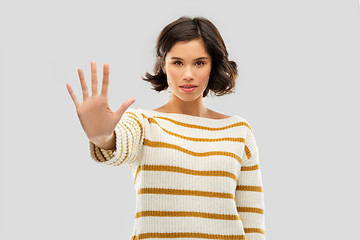 Image showing young woman making stopping gesture