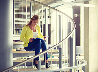 Image showing smiling high school student girl reading book