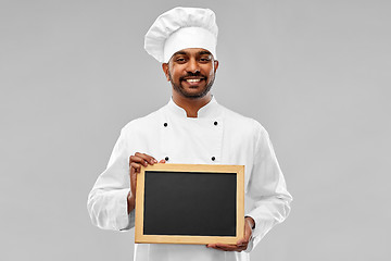 Image showing happy male indian chef in toque with chalkboard