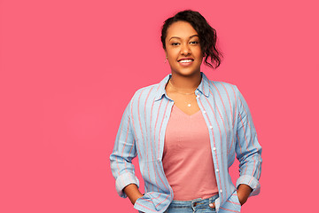 Image showing happy african american woman over pink background