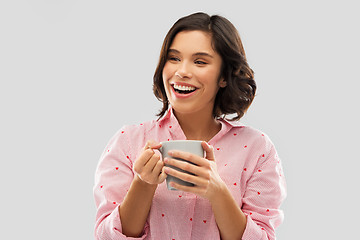 Image showing happy young woman in pajama with mug of coffee