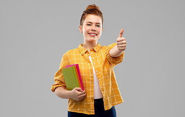 Image showing teenage student girl with books showing thumbs up