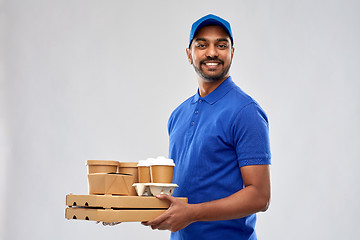 Image showing happy indian delivery man with food and drinks