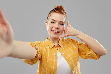 Image showing teenage girl taking selfie making calling gesture
